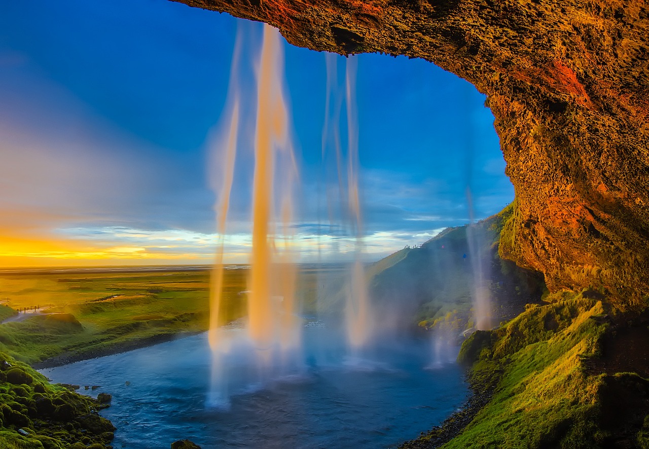 Skogafoss waterfall in South Iceland, a 60-meter cascade with rainbow in the mist