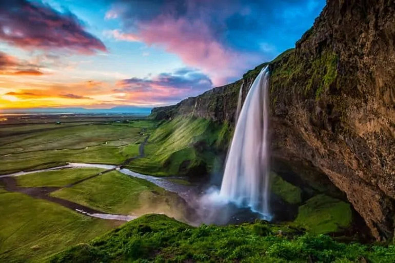 Seljalandsfoss, though not located in North Iceland or East Iceland, is more famous than Dynjandi waterfall because people can walk behind it