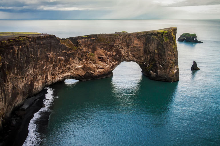 Dyrholaey Arch rock formation and sea in Iceland